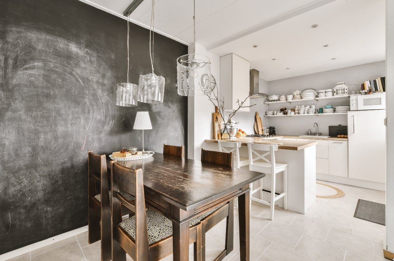 Dark wood dining table and chairs in white kitchen