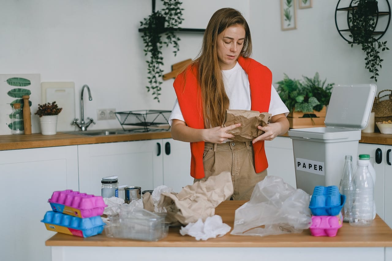 Young woman sorting trash for recycling