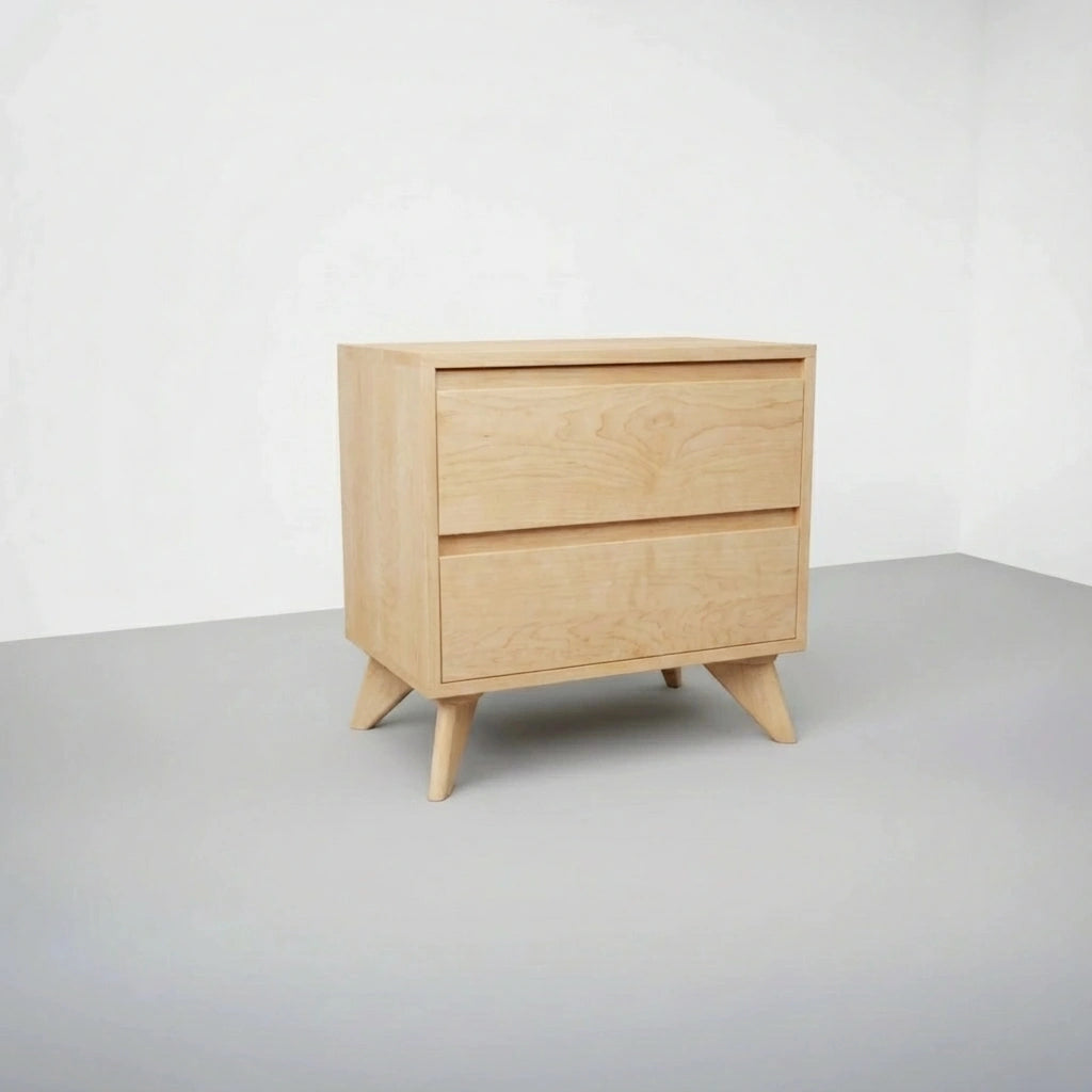 The Modern Cube Side Table by TY Fine Furniture, crafted from maple with solid wood construction and angled legs, stands in an empty room with light gray flooring and white walls.