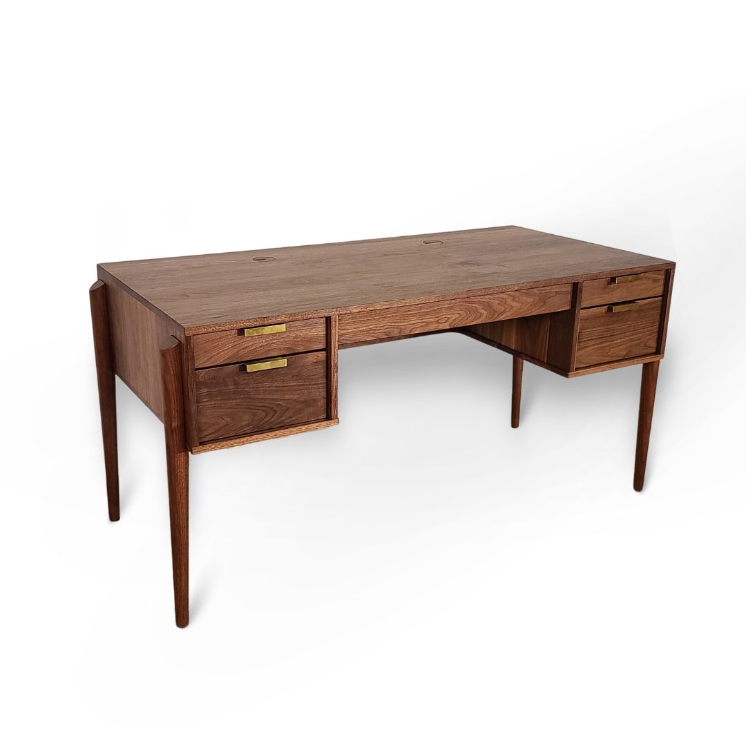 The Apollo Solid Wood Executive Desk by TY Fine Furniture, handcrafted in Columbus, Ohio, features four drawers with brass handles, tapered legs, and a smooth rectangular surface—ideal for elevating any home office setup. Shown against a white background.