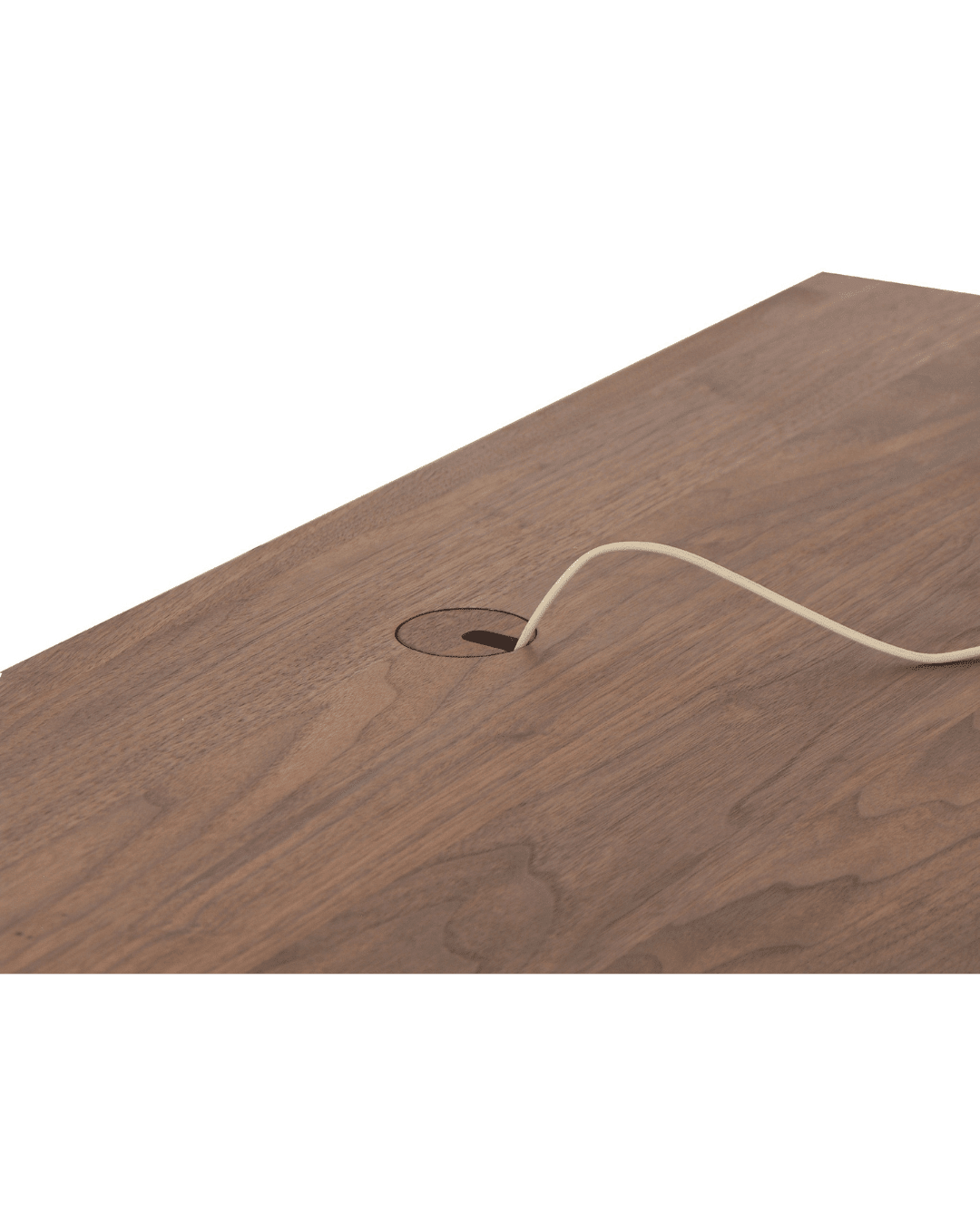 A light-colored cable passes through a circular grommet in the Enso Desk by TY Fine Furniture, a solid wood handmade artisan piece with a natural wood grain finish.