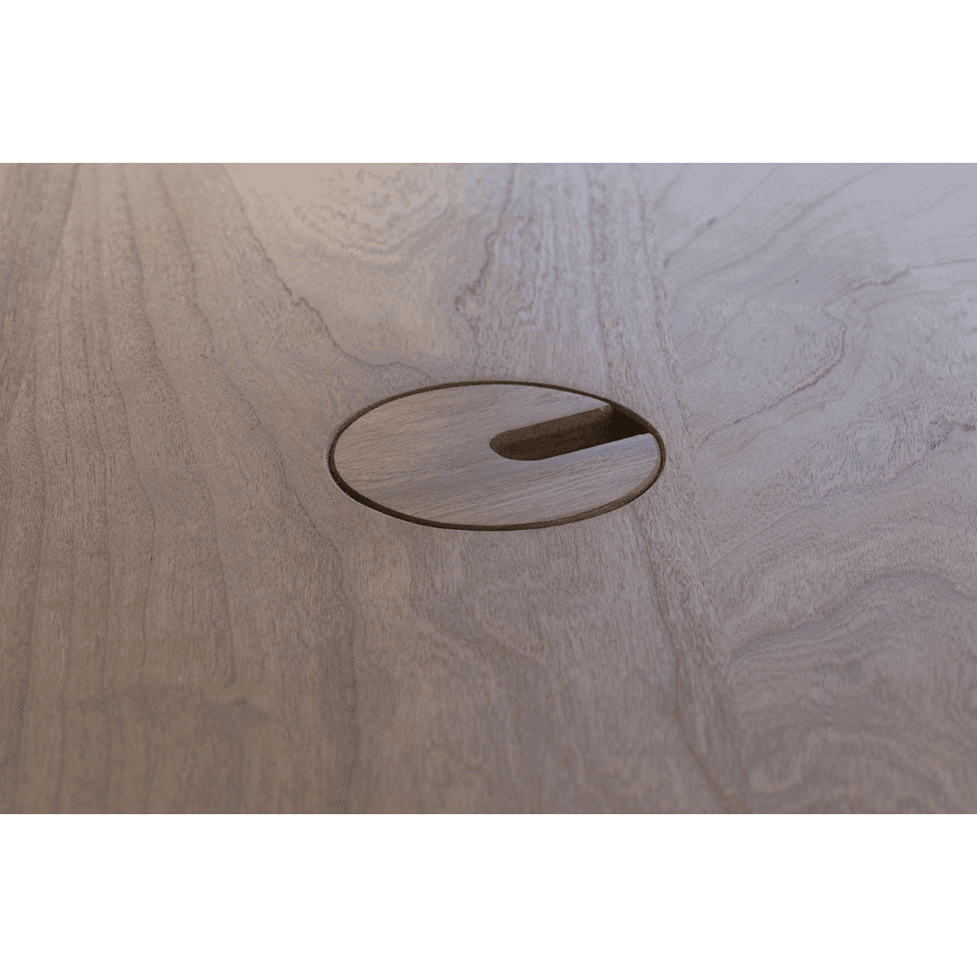 Close-up of the TY Fine Furniture Enso Sit-Stand Desk - Solid Wood Top (Columbus, OH), showing the wood grain and a circular cutout with notch designed for cable management.