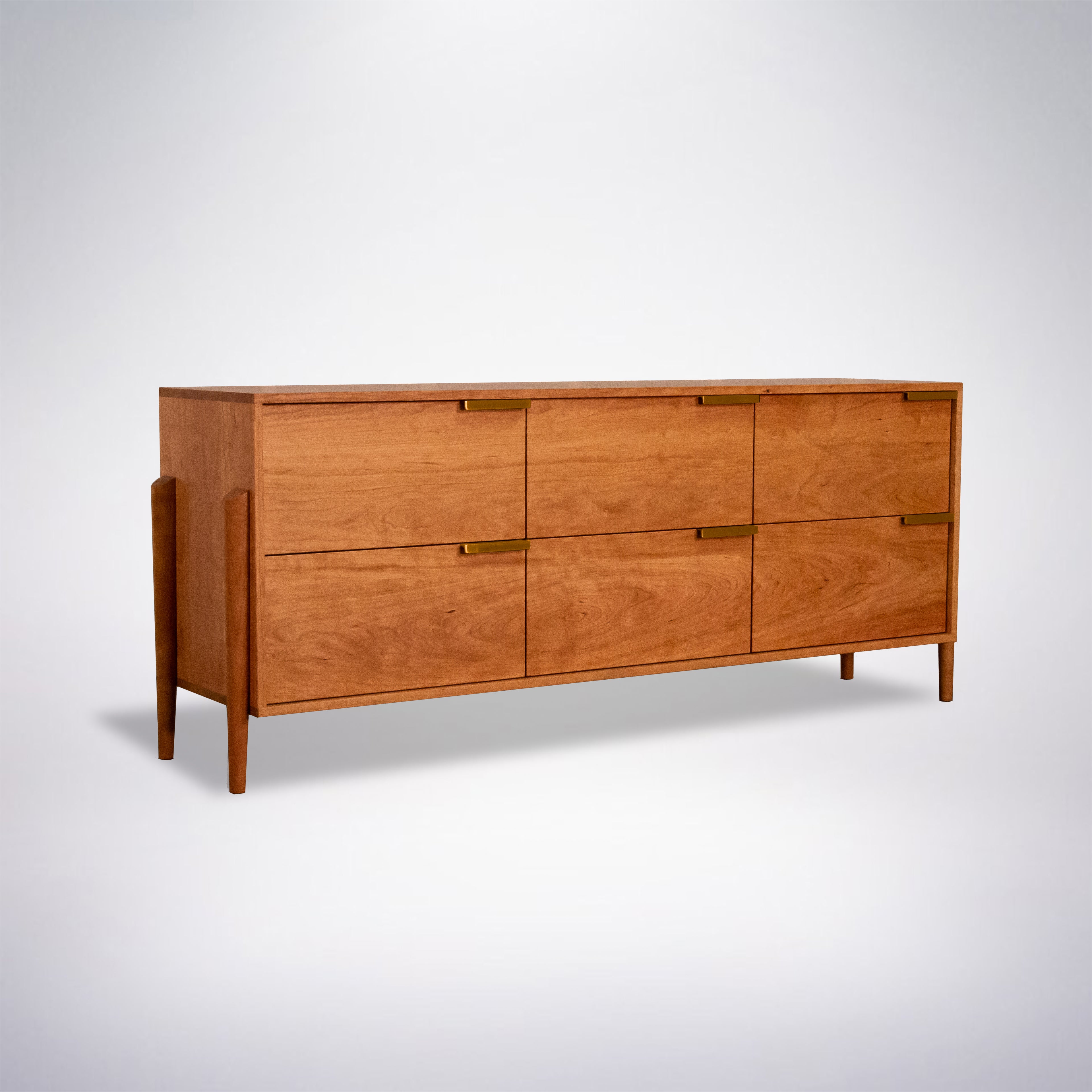 The Apollo Dresser by TY Fine Furniture is a handcrafted, mid-century modern solid cherry wood dresser with six drawers, clean lines, and slim legs—ideal for stylish bedroom storage. Photographed on a plain white background.