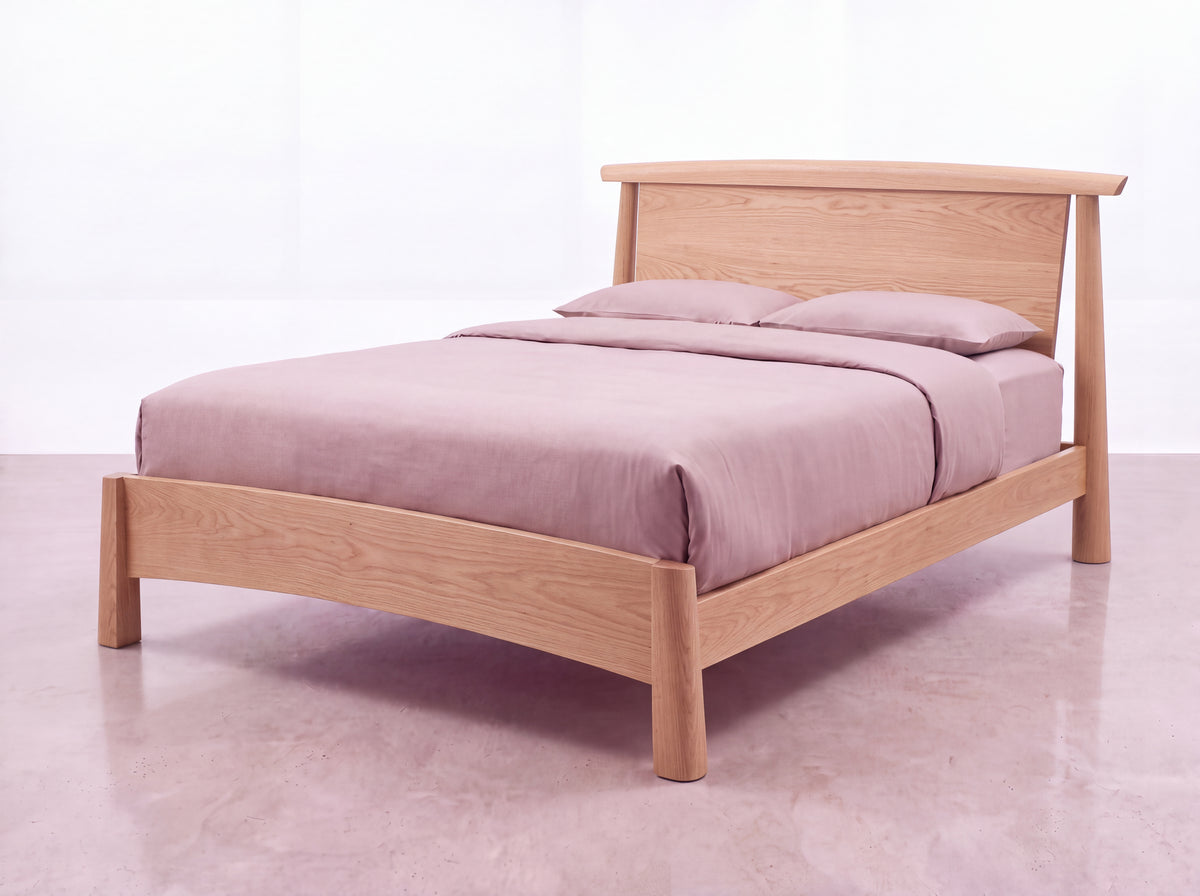 Sunrise Platform Bed - White Oak featuring a curved headboard, styled with mauve bedding and pillows.