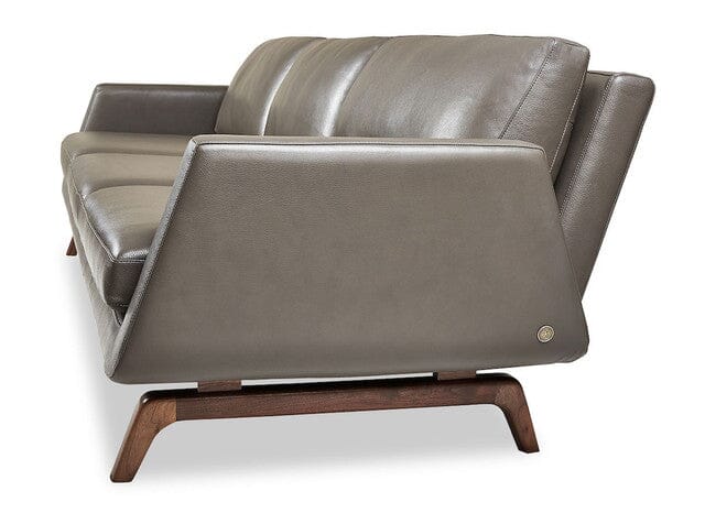 The American Leather NASH 3 & 2 Seat Sofa & Loveseat by American Leather features gray leather upholstery, angled armrests, high-density foam cushions, and a wooden base with Walnut legs for a clean, mid-century modern look.