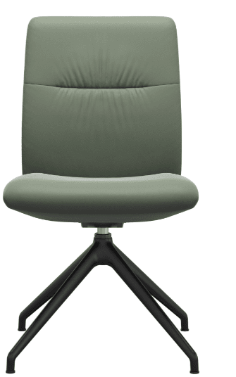 The Stressless Mint Dining Chair by Stressless is a modern green upholstered chair with a cushioned seat and backrest, set on a four-legged black metal swivel base and shown against a white background.
