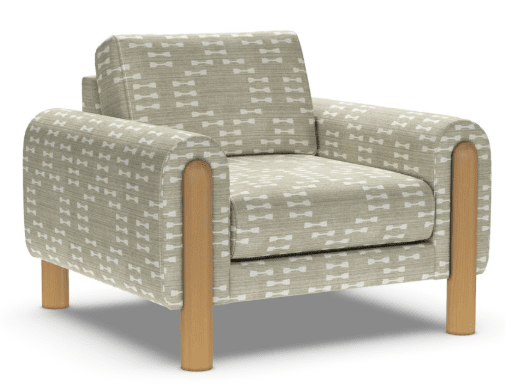 The American Leather Revie Chair by American Leather features solid walnut legs, padded armrests, and beige fabric with a white geometric pattern. Its boxy shape and high-density foam seat offer modern style and exceptional comfort.