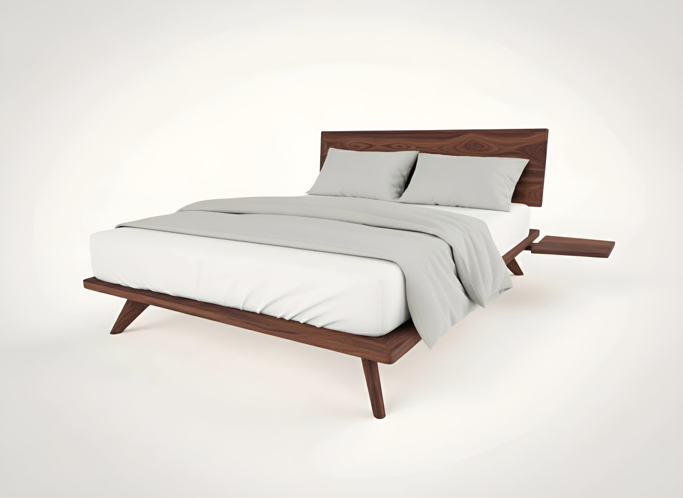 The Atomic Platform Bed by TY Fine Furniture features a solid walnut frame with angled legs, a wooden headboard, white sheets, light gray bedding, matching pillows, and a small wooden side shelf attached to the frame.