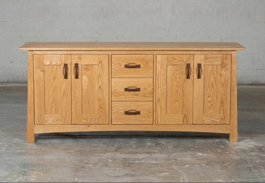 The Enso Credenza & Buffet in White Oak by TY Fine Furniture, crafted from solid wood, features double-door cabinets on each side and three central drawers—an elegant storage solution for your dining room.
