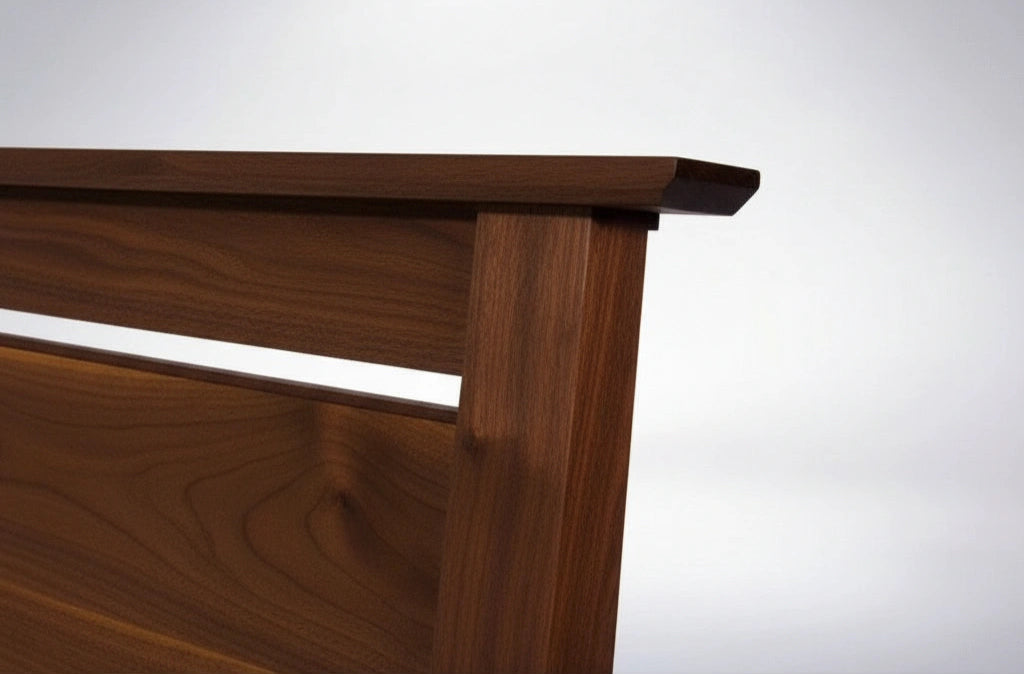 Close-up of the Enso Platform Bed Walnut by TY Fine Furniture, featuring a modern wooden headboard with a smooth finish and minimalist lines—highlighting the elegant Japanese-inspired design against a white background.