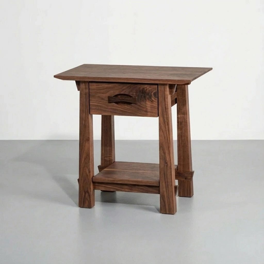The Enso Side Table With Drawer by TY Fine Furniture is a handmade solid walnut table with a rectangular top, carved-handle central drawer, and lower shelf, displayed against a plain light background.