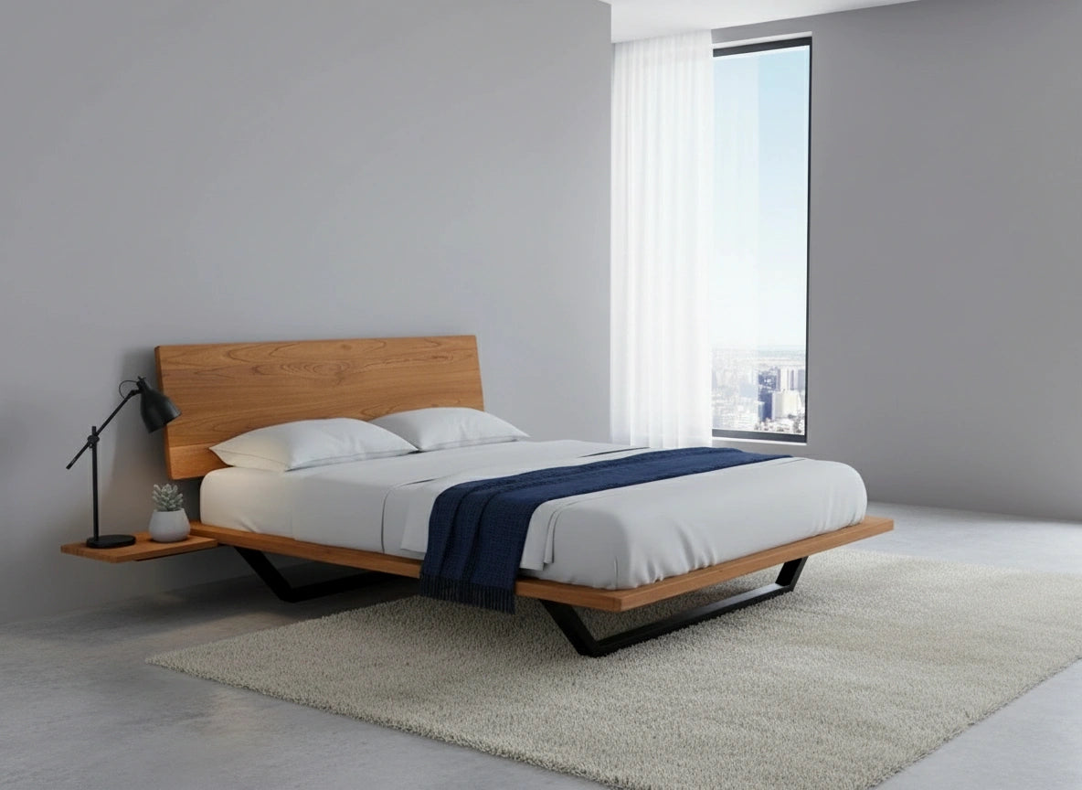 A modern bedroom with the TY Fine Furniture Nelson Solid Wood Platform Bed Frame in cherry, white bedding, a navy throw, black floor lamp, potted plant on a floating nightstand, large window, and light beige rug on a gray floor.