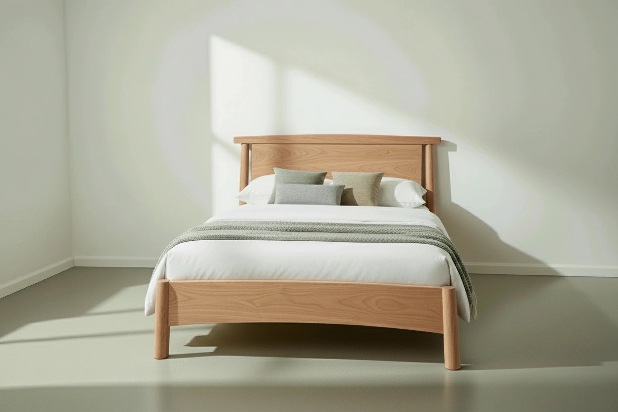 Wooden bed with white bedding in a minimalist bedroom