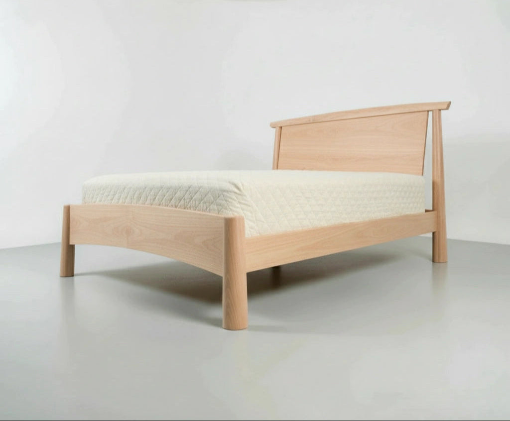 Wooden bed with a white mattress on a plain background