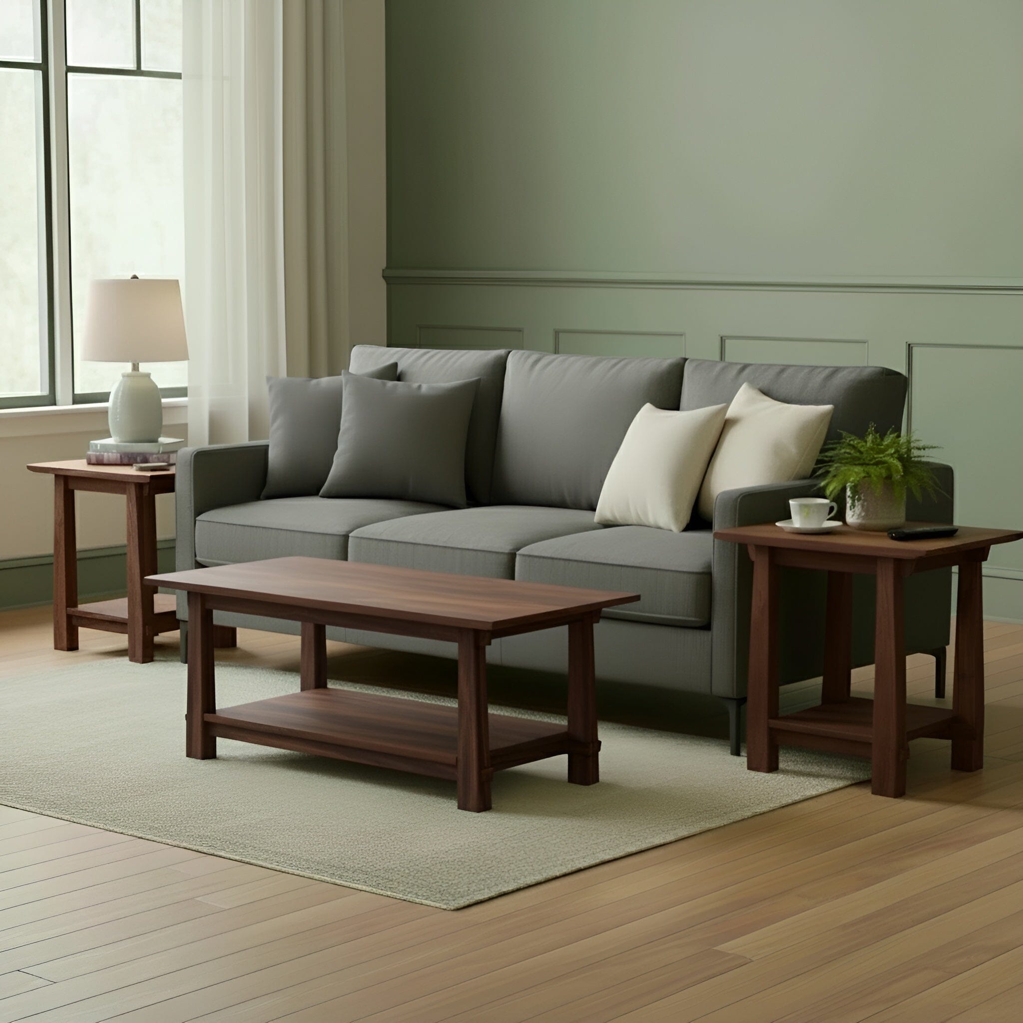 A living room with a gray sofa, white and beige pillows, a premium walnut coffee table, TY Fine Furniture Horizon Side Tables in solid walnut, a table lamp, potted plant, large window with white curtains, light green walls, and wood floors in Japanese-inspired design.