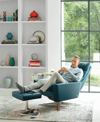 Man sitting on blue recliner and ottoman