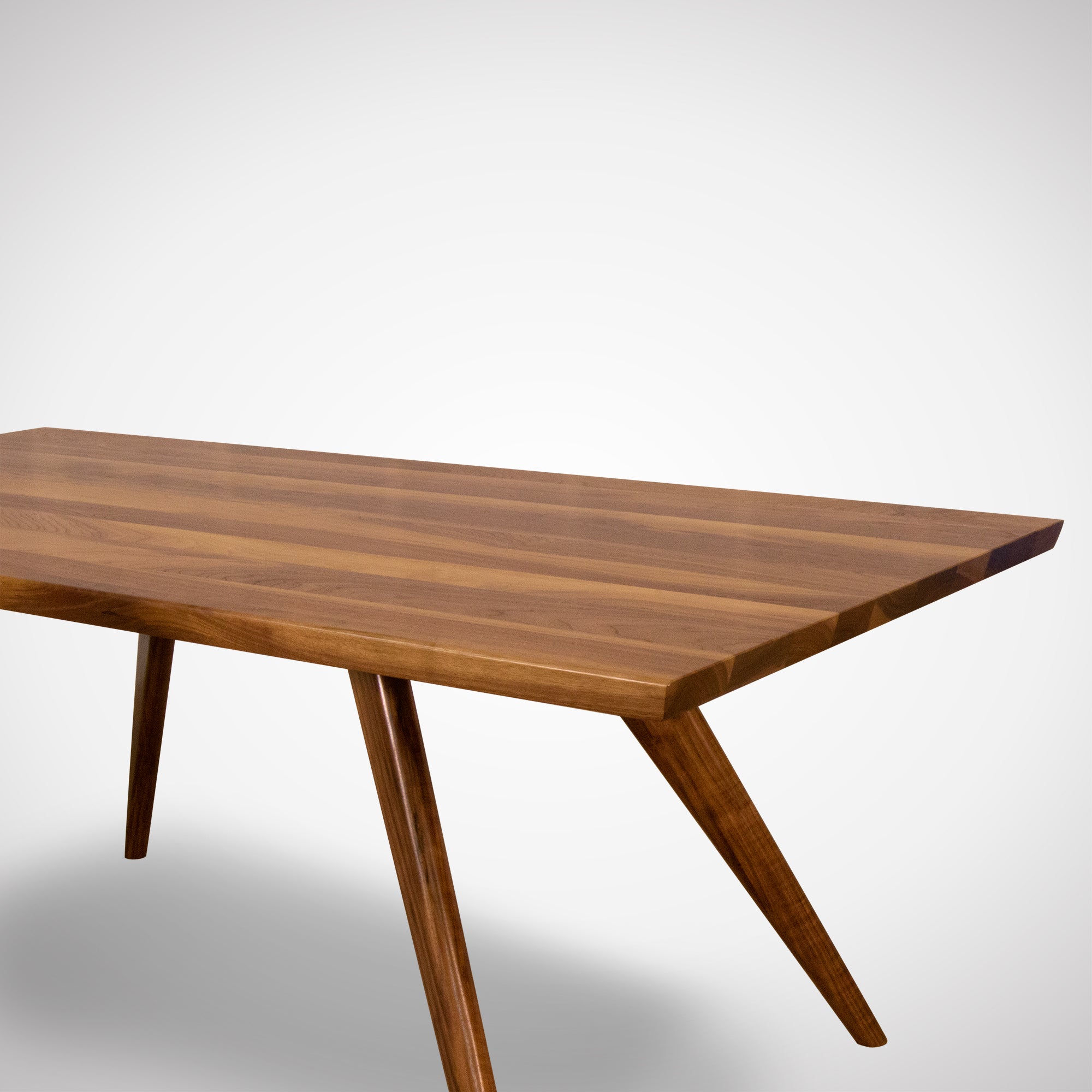 A close up of a modern solid wood dining table