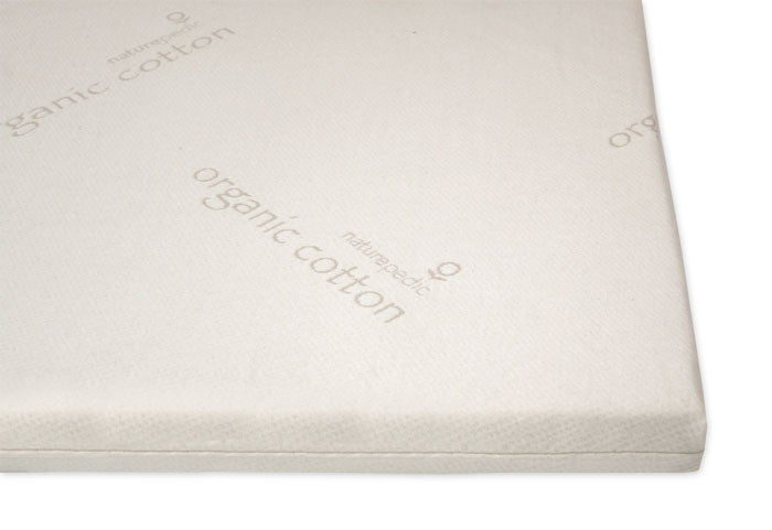 The Naturepedic Organic Latex Mattress Topper is a rectangular, white organic cotton topper designed for breathable comfort and gentle pressure point relief, featuring subtle light gray “naturepedic” text on its surface.