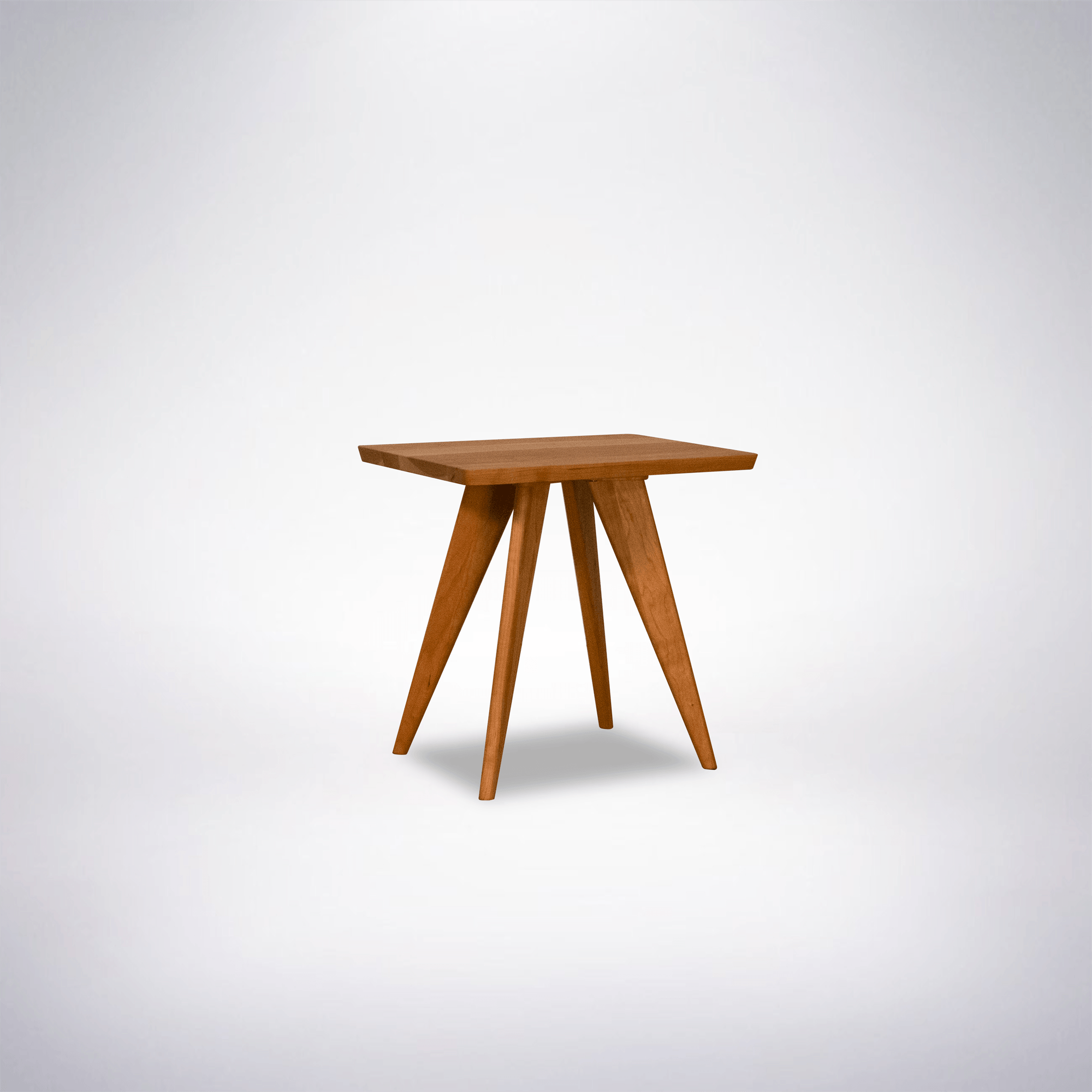 The Essentials Solid Wood Side Table Cherry by TY Fine Furniture is a small, modern Mid Century Modern table with a solid wood top and four angled legs, shown on a plain white background.