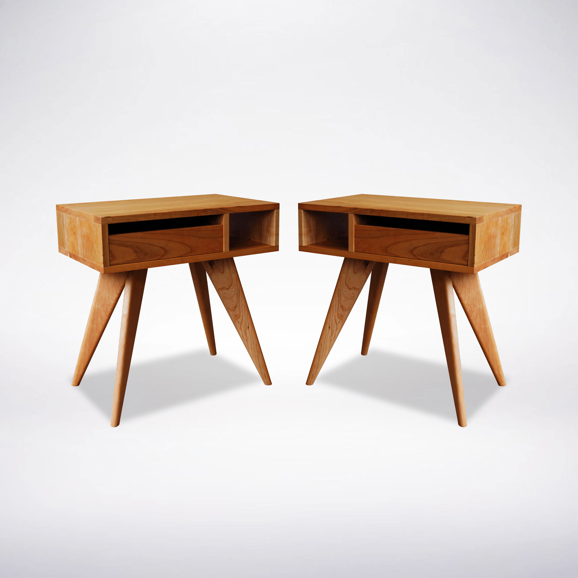 A pair of TY Fine Furniture Mid-Century Modern Side Tables in cherry, each with angled legs, open shelf, and single drawer—ideal beside platform beds—displayed on a plain white background.