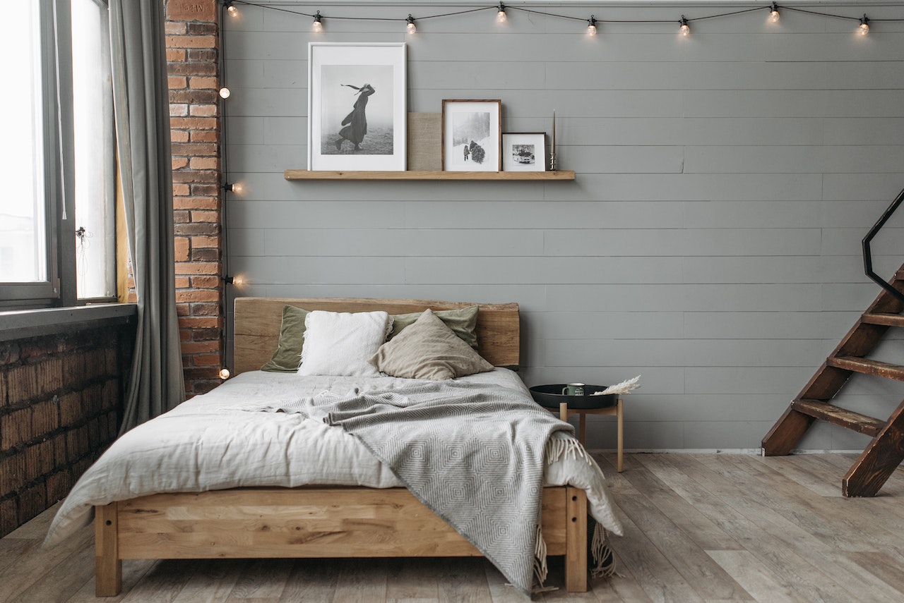 A Bedroom With Gray Walls and Wooden Floor