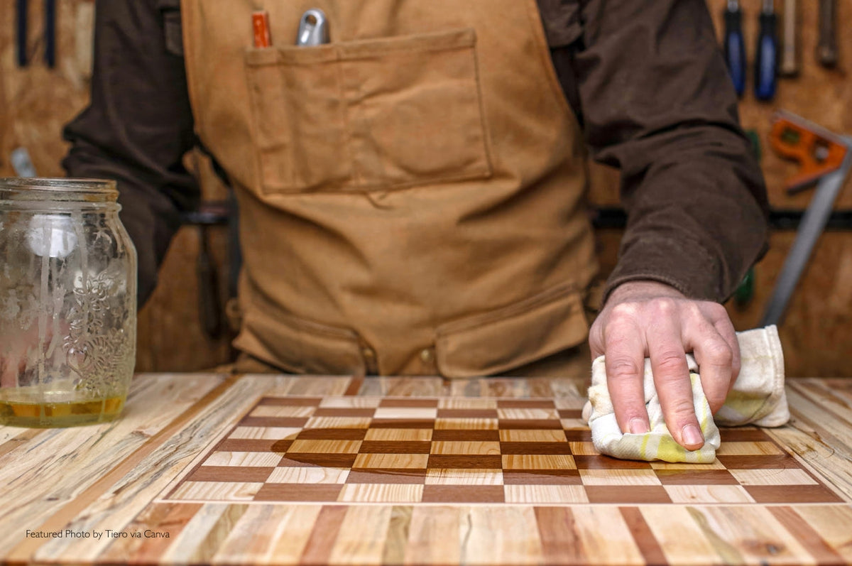 carpenter applying wood finish