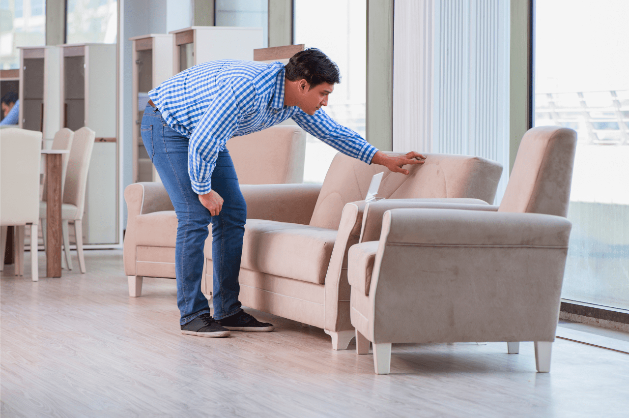 Man inspecting a sofa in the store