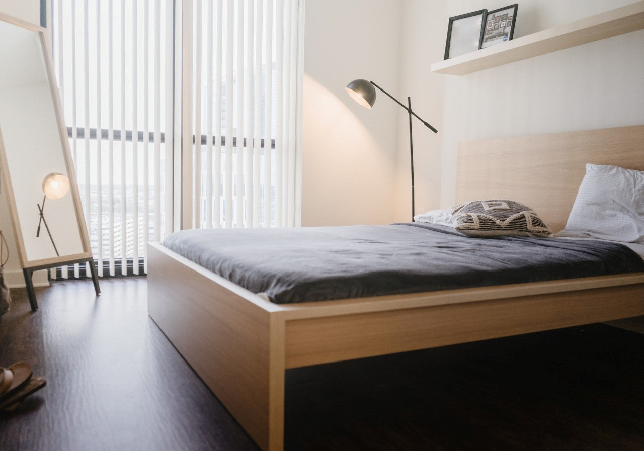 Modern minimalist apartment with bed and view of city