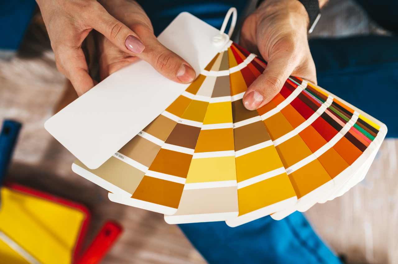 Person holding color samples for wall paint