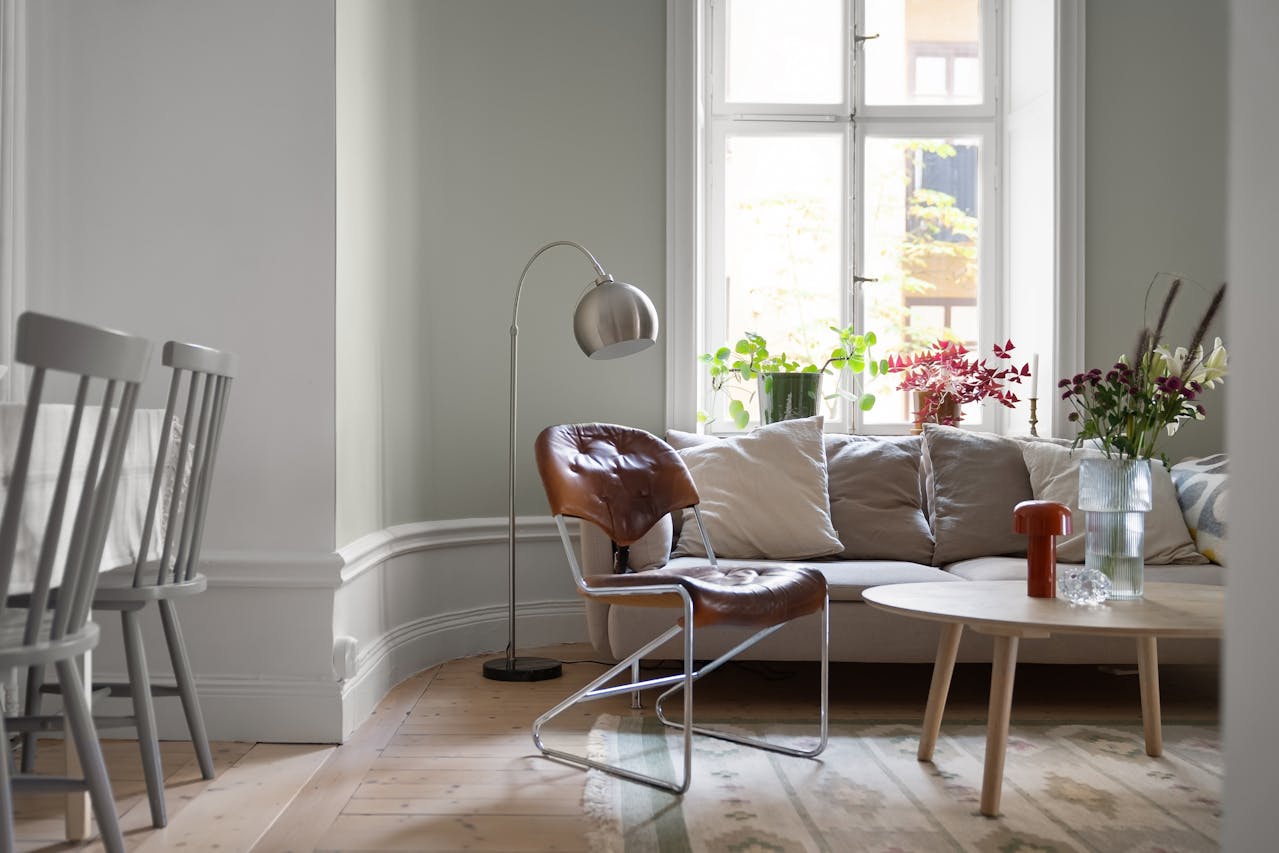 interior design of an open plan living room and dining area with an accent chair between spaces