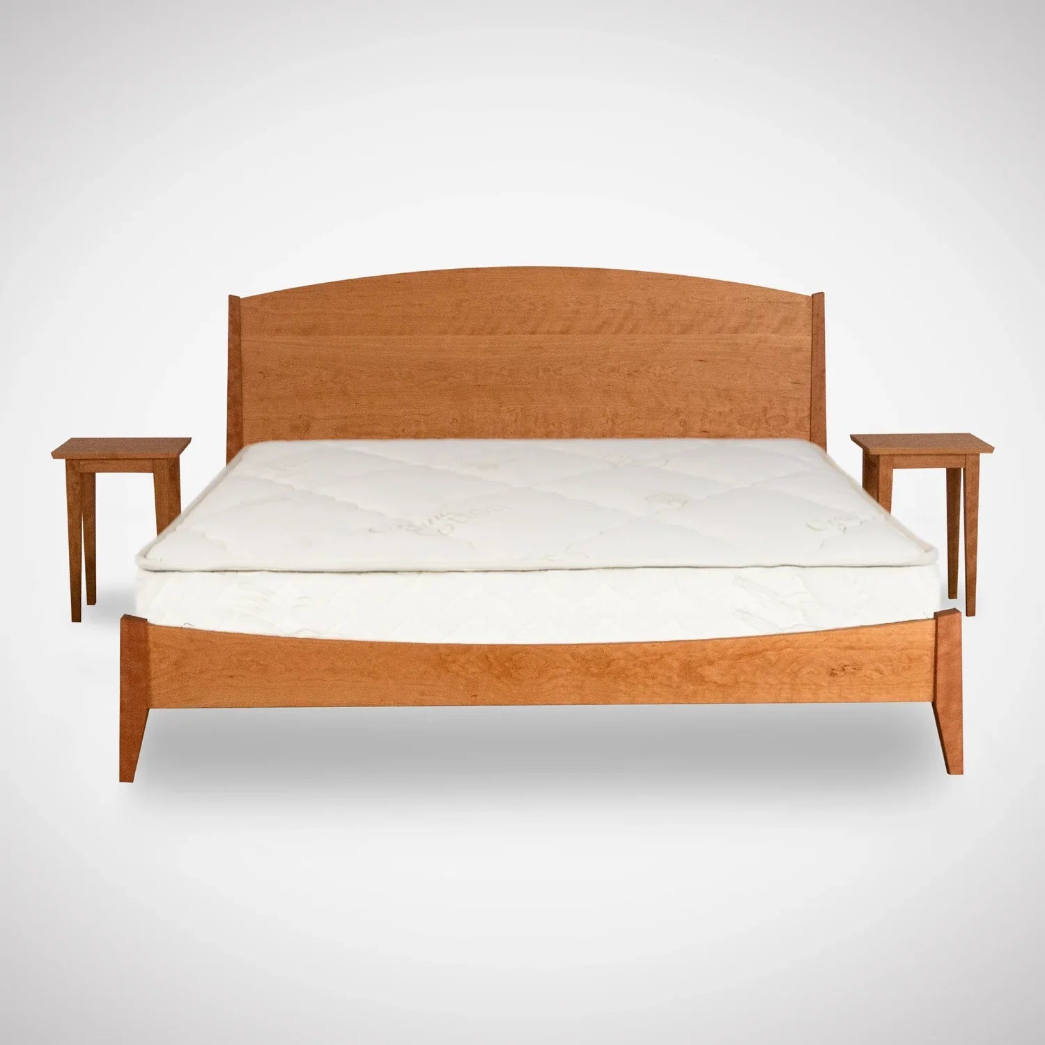 A wooden bed frame with a curved headboard and white mattress, flanked by two matching wooden nightstands, all set against a plain white background.