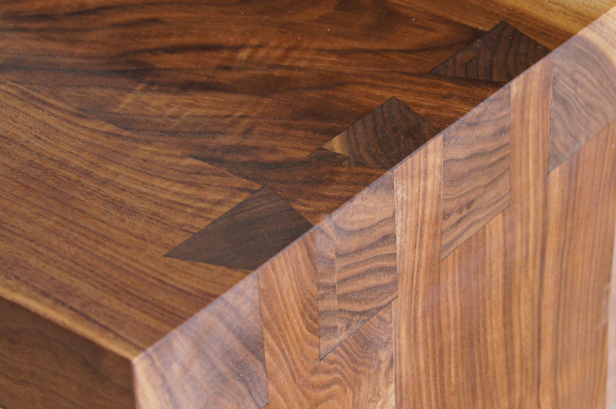 Close-up of the Solid Cherry Wood Bench - Enso Collection | TY Fine Furniture, showcasing precise dovetail joinery and beautiful grain patterns that reflect exceptional Japanese woodworking craftsmanship.