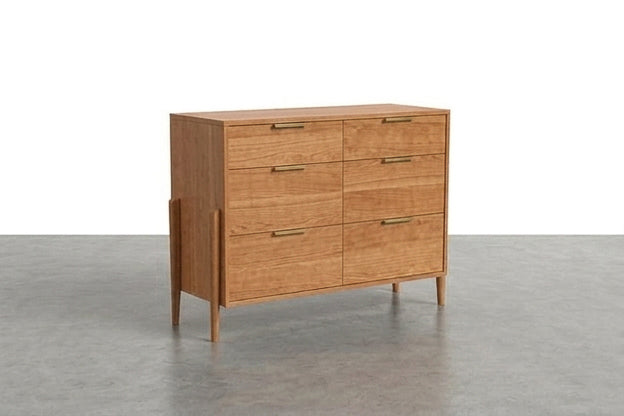 The Solid Cherry 6-Drawer Double Bank Dresser from the Apollo Collection by TY Fine Furniture, featuring slim brass handles, stands on tapered legs against a plain white background on a gray floor.