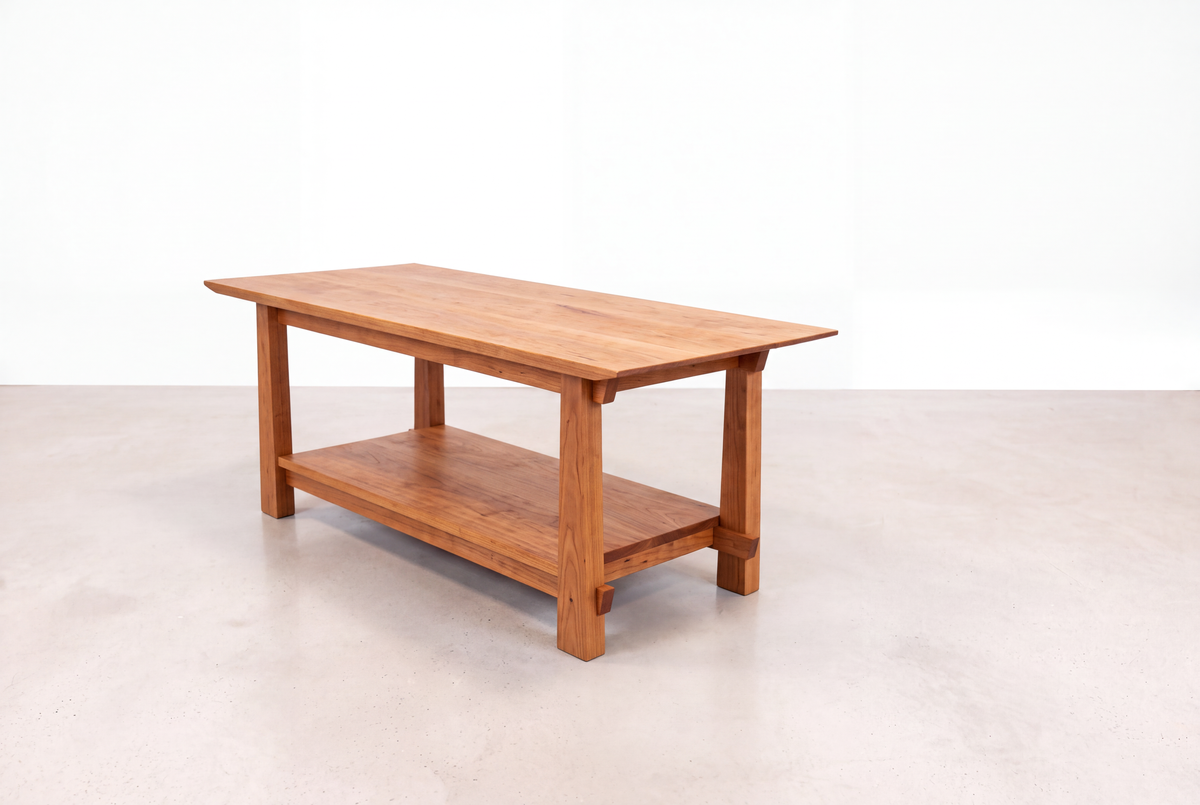 A Solid Cherry Horizon Coffee Table from the Horizon Collection by TY Fine Furniture, featuring a lower shelf and showcasing Japanese craftsmanship, is placed on a light-colored floor against a plain white background.