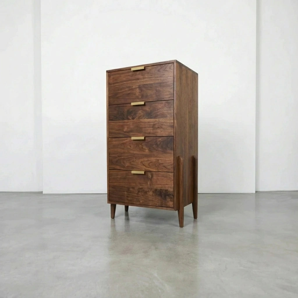 The TY Fine Furniture Apollo Tall Dresser in cherry features solid wood construction, brass handles, soft close drawers, and tapered legs, shown in an empty room with white walls and a polished concrete floor.
