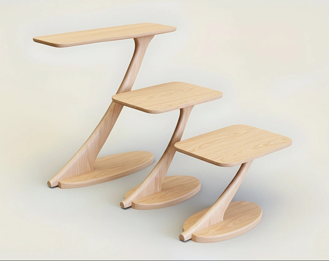 Three Cantilever Side Tables from TY Fine Furniture, handmade from solid maple, feature curved bases and single angled supports, arranged in a staggered display to highlight stylish, eco-friendly craftsmanship against an off-white backdrop.