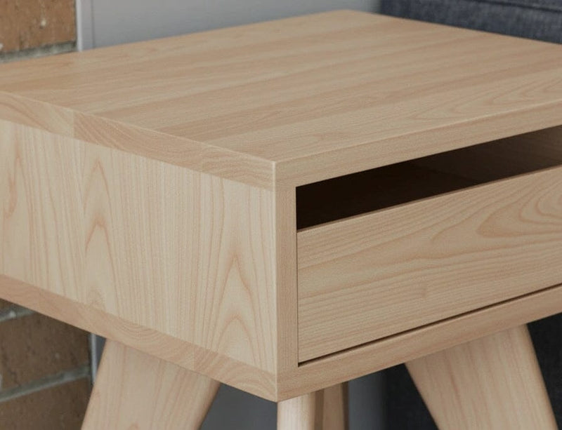 Close-up of the light wood side table's drawer and surface.