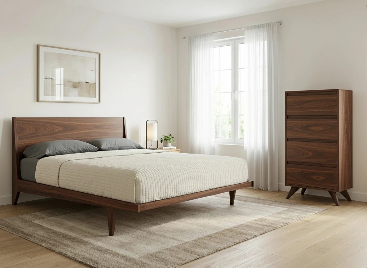 A minimalist bedroom with a wooden bed frame, beige bedding, gray pillows, a Tall Modern Dresser Mid Century by TY Fine Furniture in walnut, light wood floors, a textured rug, sheer white curtains on the window, and neutral wall art above the bed.
