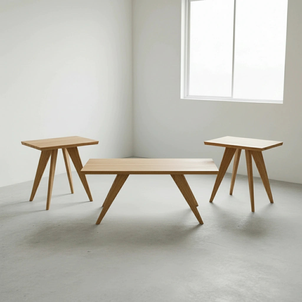 Three Essentials Solid Wood Side Tables by TY Fine Furniture, crafted in white oak with angled legs, are arranged in a bright, minimalist room with white walls and a large window. Their Mid Century Modern design is simple and modern.