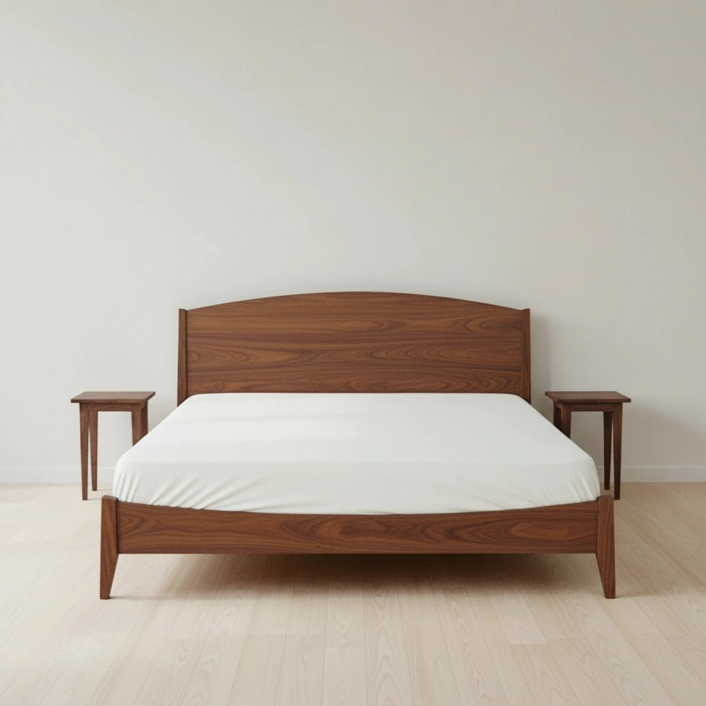 A T.Y. Fine Furniture Shaker Platform Bed – Solid Wood Bed Frame Walnut with a white sheet sits between two matching wooden nightstands in a minimalist room with light wood flooring and plain white walls.