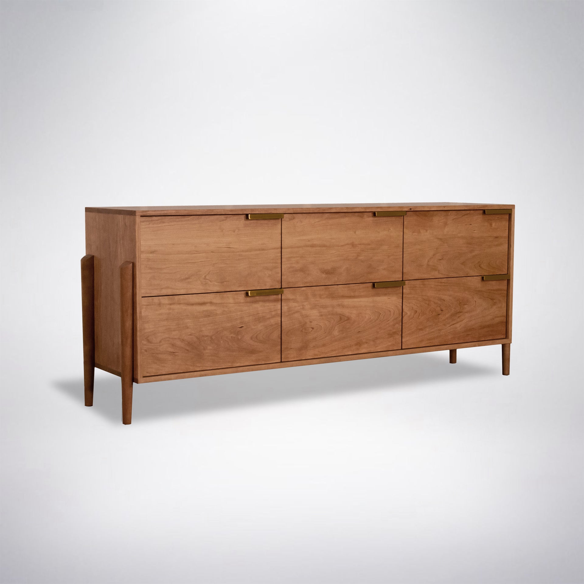Modern dresser in natural cherry wood with brass handles