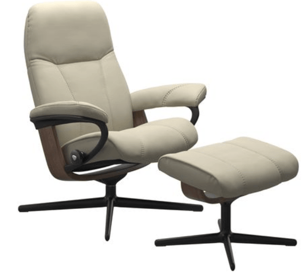 Close-up of beige leather ergonomic chair with ottoman and five-star wheel base.