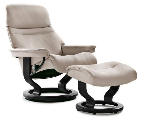 Beige leather reclining chair with matching ottoman, modern design.